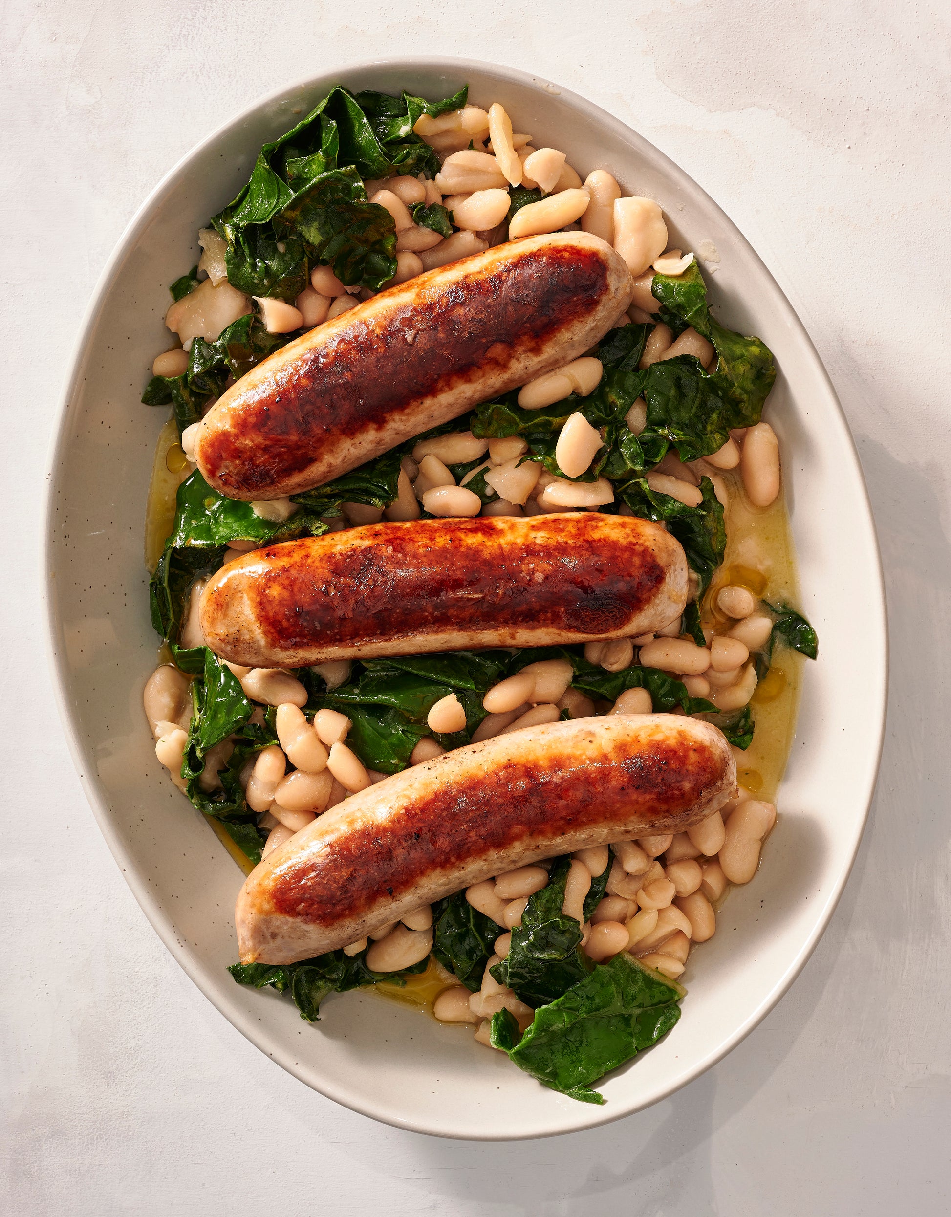 Kasekrainer over beans and greens.