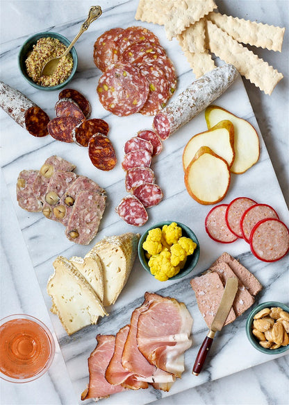 Sliced salami on charcuterie board.