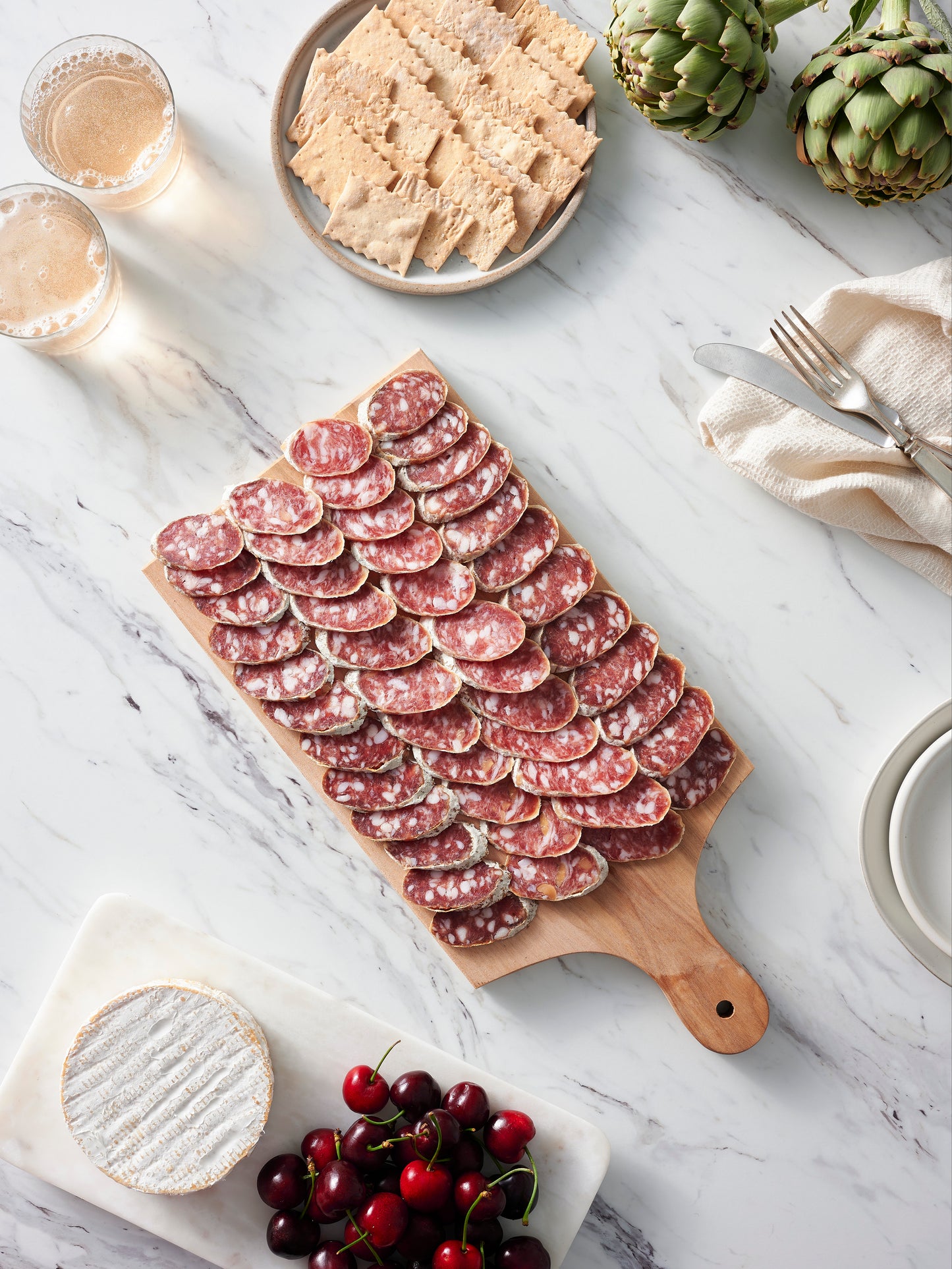 Sliced salami on cutting board.